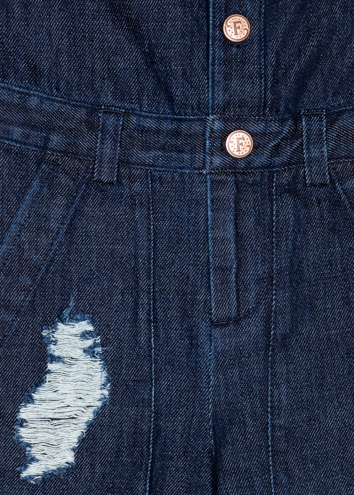 Close-up of denim jumpsuit fabric with button closures and distressed patch