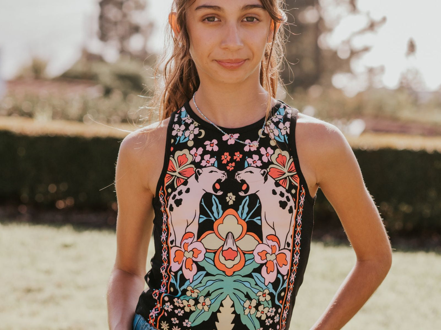 Tween in Finding Foxtale's Lucy Top in front of orange tree