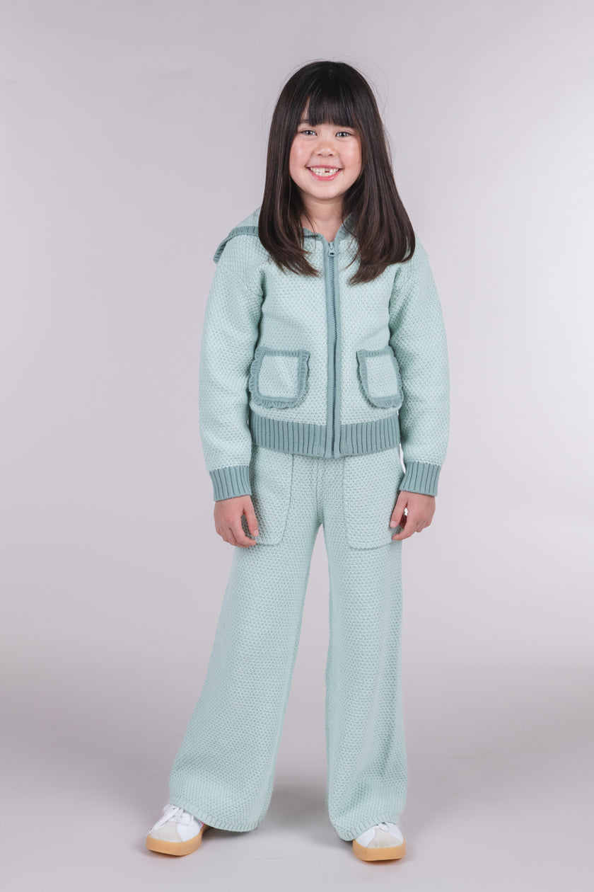 Tween girl wearing seafoam green knit zipper jacket with matching wide leg pants