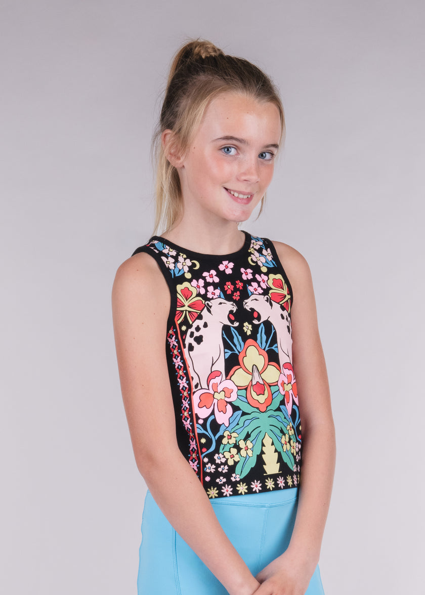 Tween girl wearing a black tank top with colorful floral and panther print